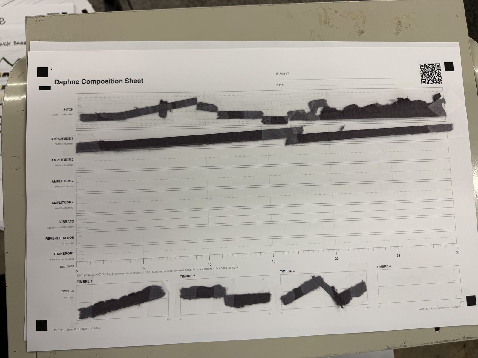 A composition sheet drawn by hand at the first workshop, with lines across the pitch, amplitude, vibrato, reverberation and transport lanes and four waveforms at the foot
